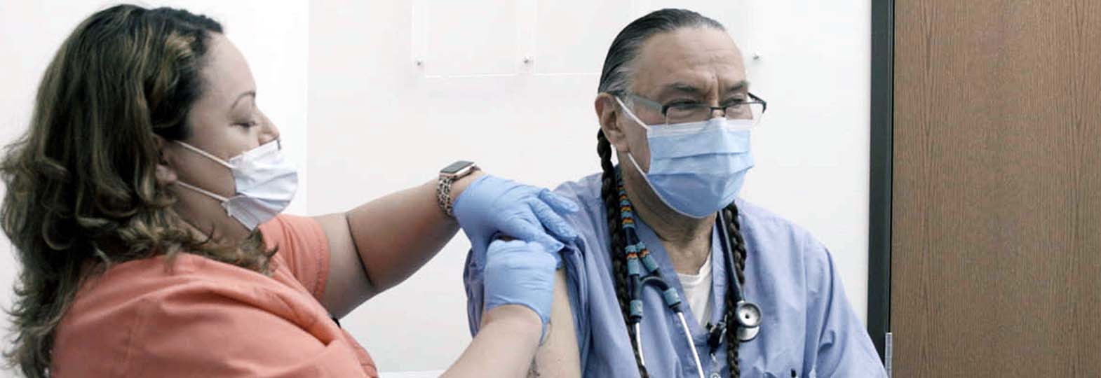 native american man getting a flu shot
