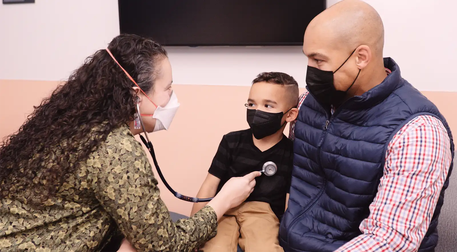 Native American pediatrician with child and parent