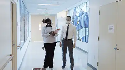 Doctor and nurse walking in hospital